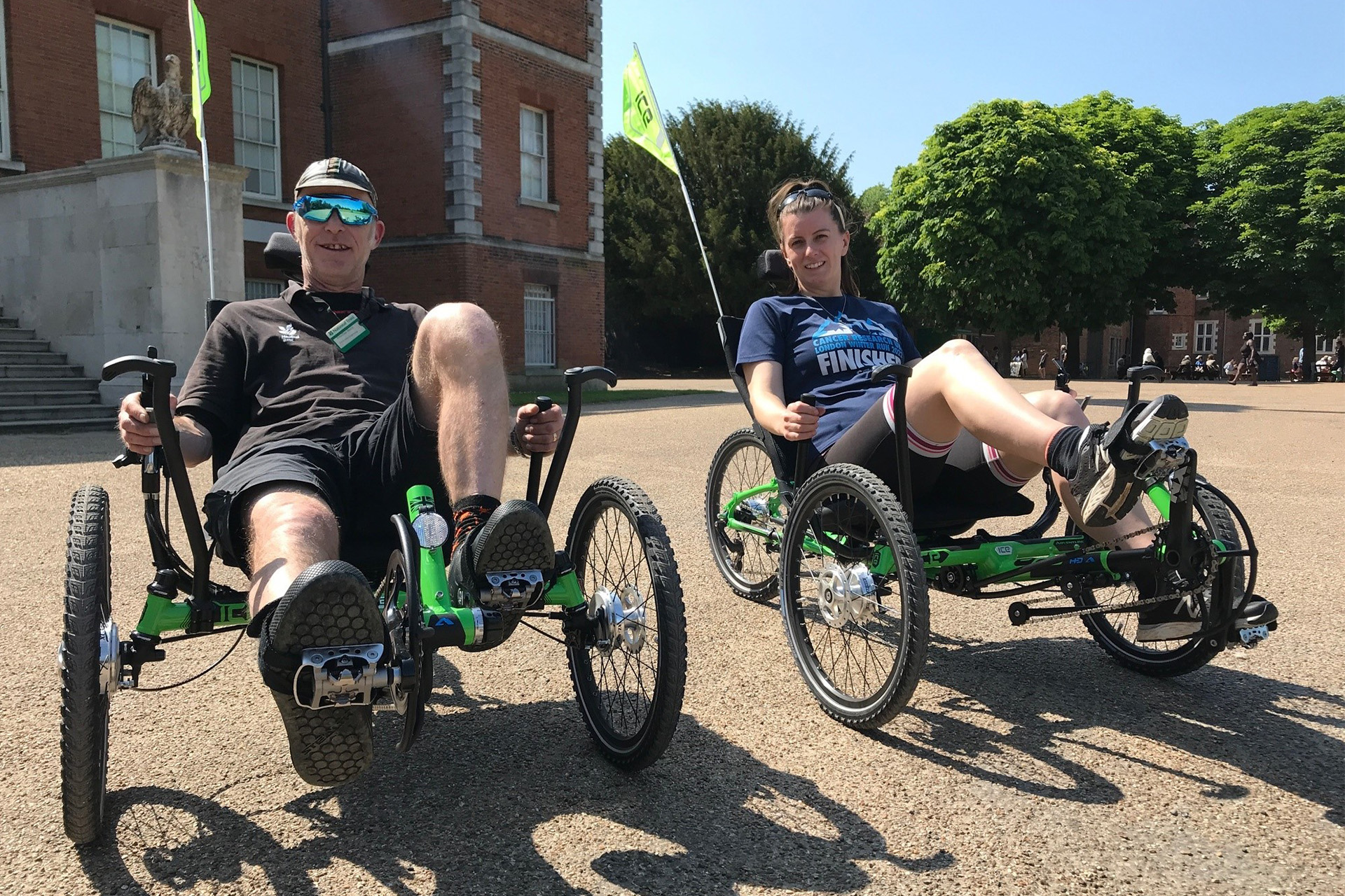two trike riders smiling